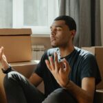 Man in Black Crew Neck T-shirt Sitting on Brown Sofa